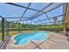 This screened-in pool and patio area has relaxing outdoor seating with gorgeous water views at 14502 Pond Cypress Way, Tampa, FL 33626
