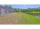 View of the screened pool in the backyard with a picturesque pond in the background at 14502 Pond Cypress Way, Tampa, FL 33626