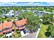 Aerial view of the property in a community with a pool and tennis court at 14561 El Paseo Dr, Seminole, FL 33776