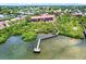 Aerial view of the property featuring a pier and waterfront access at 14561 El Paseo Dr, Seminole, FL 33776