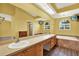 Primary bathroom featuring double vanity, soaking tub and large mirrors at 14561 El Paseo Dr, Seminole, FL 33776