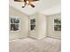 Carpeted bedroom featuring two windows providing ample natural light at 14561 El Paseo Dr, Seminole, FL 33776