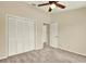 Bedroom featuring a ceiling fan, neutral walls, plush carpeting, and a closet with louvered doors at 14561 El Paseo Dr, Seminole, FL 33776