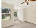Cozy bedroom with carpet, a ceiling fan, and a view of the yard at 14561 El Paseo Dr, Seminole, FL 33776
