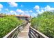 Take a scenic stroll on the community boardwalk surrounded by lush greenery at 14561 El Paseo Dr, Seminole, FL 33776