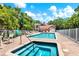 Relax and unwind at the community pool and spa, surrounded by lush landscaping at 14561 El Paseo Dr, Seminole, FL 33776