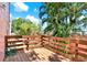 Outdoor wooden deck surrounded by lush tropical landscaping at 14561 El Paseo Dr, Seminole, FL 33776