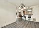 Open dining area with gray flooring, bar stool seating, and a decorative chandelier above at 14561 El Paseo Dr, Seminole, FL 33776