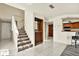 Bright entryway featuring tile flooring, a staircase, and a built-in wine rack at 14561 El Paseo Dr, Seminole, FL 33776