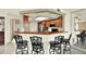 Kitchen with a breakfast bar featuring wood cabinets and stainless appliances at 14561 El Paseo Dr, Seminole, FL 33776
