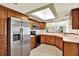 Well-lit kitchen featuring wood cabinets, stainless steel appliances, and a skylight at 14561 El Paseo Dr, Seminole, FL 33776