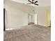 Open living room with neutral carpet, tall ceilings, and multiple doorways at 14561 El Paseo Dr, Seminole, FL 33776