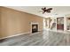Spacious living room featuring wood floors, a fireplace and staircase at 14561 El Paseo Dr, Seminole, FL 33776