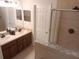 Bathroom features double vanity, walk-in shower and decorative tile accents at 1508 Talisker Dr, Clearwater, FL 33755
