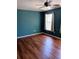 Comfortable bedroom with warm brown hardwood flooring and a ceiling fan at 1508 Talisker Dr, Clearwater, FL 33755