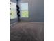 Bedroom with neutral paint, carpet and bright window with blinds at 1508 Talisker Dr, Clearwater, FL 33755