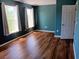 Bedroom with wood floors, teal walls, white trim and natural light from two windows at 1508 Talisker Dr, Clearwater, FL 33755