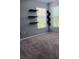 Bedroom with neutral paint, shelving, carpet and bright window with blinds at 1508 Talisker Dr, Clearwater, FL 33755