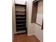 Walk-in closet with custom shelving and hardwood floors at 1508 Talisker Dr, Clearwater, FL 33755