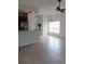 Open-concept living area with kitchen in the background, tile flooring, and natural light from a window at 1508 Talisker Dr, Clearwater, FL 33755