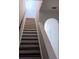 Staircase featuring wood treads, white risers and bannister, leading to the upper level at 1508 Talisker Dr, Clearwater, FL 33755