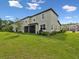 Backyard with a view of lawn, screen-in patio, landscaping and grass at 17729 Nectar Flume Dr, Land O Lakes, FL 34638