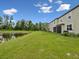 Backyard featuring a serene pond view, mature trees, and greenery at 17729 Nectar Flume Dr, Land O Lakes, FL 34638