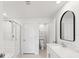Sleek bathroom featuring tile flooring, glass-enclosed shower, toilet, vanity, and modern black mirror at 17729 Nectar Flume Dr, Land O Lakes, FL 34638