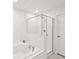 Bright bathroom featuring white tiling and a glass enclosed shower at 17729 Nectar Flume Dr, Land O Lakes, FL 34638