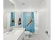 Bright bathroom featuring a shower with a cute animal-themed curtain and white tiling at 17729 Nectar Flume Dr, Land O Lakes, FL 34638