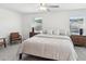 Spacious bedroom with two windows, neutral walls, carpet, ceiling fan, and two nightstands at 17729 Nectar Flume Dr, Land O Lakes, FL 34638