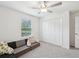 Bedroom features a view of the outdoors, carpet, neutral walls, a ceiling fan, and a closet at 17729 Nectar Flume Dr, Land O Lakes, FL 34638