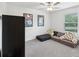 A cozy bedroom with a casual seating area, carpet, and stylish decor at 17729 Nectar Flume Dr, Land O Lakes, FL 34638