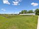 Expansive community farm showcasing rows of crops, a greenhouse, and open green space on a sunny day at 17729 Nectar Flume Dr, Land O Lakes, FL 34638