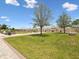 Lush community garden with well-maintained plots, pergola, and seating area under a sunny sky at 17729 Nectar Flume Dr, Land O Lakes, FL 34638