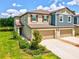 Beautiful two-story townhome with attached two-car garage and landscaped front yard at 17729 Nectar Flume Dr, Land O Lakes, FL 34638