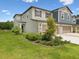 Two-story townhouse featuring a well-maintained lawn, landscaping, and an attached two-car garage at 17729 Nectar Flume Dr, Land O Lakes, FL 34638