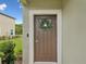 Inviting front door with wreath, digital lock and light paint trim offering a warm welcome at 17729 Nectar Flume Dr, Land O Lakes, FL 34638