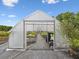 Spacious greenhouse featuring rows of plants and natural light for optimal growing conditions at 17729 Nectar Flume Dr, Land O Lakes, FL 34638