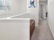 Well-lit hallway with neutral carpet and stylish decor at 17729 Nectar Flume Dr, Land O Lakes, FL 34638