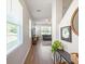 Bright hallway with wood floors, neutral paint, leading to living room and stairway to the second floor at 17729 Nectar Flume Dr, Land O Lakes, FL 34638