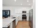 Modern kitchen featuring stainless steel appliances, white cabinets, and quartz countertops at 17729 Nectar Flume Dr, Land O Lakes, FL 34638