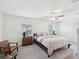 Well-lit main bedroom with ceiling fan, neutral walls, carpet floors, and views of the backyard at 17729 Nectar Flume Dr, Land O Lakes, FL 34638