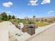 Organized raised garden beds in a community garden space, featuring gravel pathways and greenery under a sunny sky at 17729 Nectar Flume Dr, Land O Lakes, FL 34638