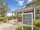 Close-up of Welcome Center entrance with clear signage and vibrant flower planters on a sunny day at 17729 Nectar Flume Dr, Land O Lakes, FL 34638