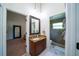 Bathroom with a stylish vanity and mirror, with a shower, and tile flooring at 1903 Curry Rd, Lutz, FL 33549