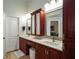 This bathroom features a double sink vanity with marble countertops and a stylish framed mirror at 1903 Curry Rd, Lutz, FL 33549