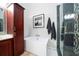The bathroom features a soaking tub, glass-enclosed shower, modern fixtures, and cherry wood cabinet at 1903 Curry Rd, Lutz, FL 33549