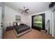 Bedroom featuring a ceiling fan, large window, neutral color palette, and carpeted flooring at 1903 Curry Rd, Lutz, FL 33549