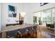 Formal dining room features hardwood floors, elegant chandelier, and sliding doors to patio with outdoor dining at 1903 Curry Rd, Lutz, FL 33549
